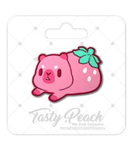 Load image into Gallery viewer, Pink strawberry capybara character with green leaves on a white background with 'Tasty Peach' branding.
